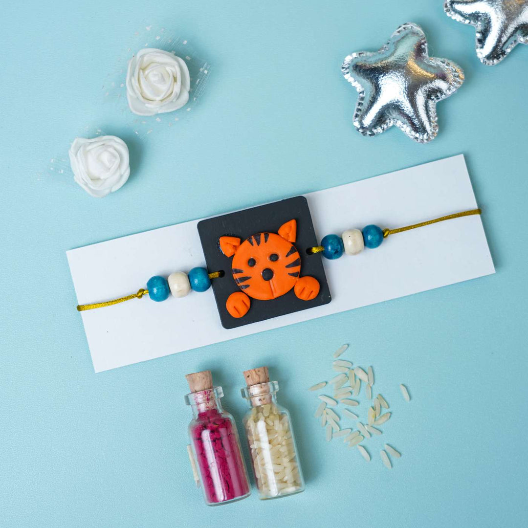 Handmade Miniature Clay Tiger Themed Kids Rakhi With Roli Chawal - Bracelet on card with decorative items