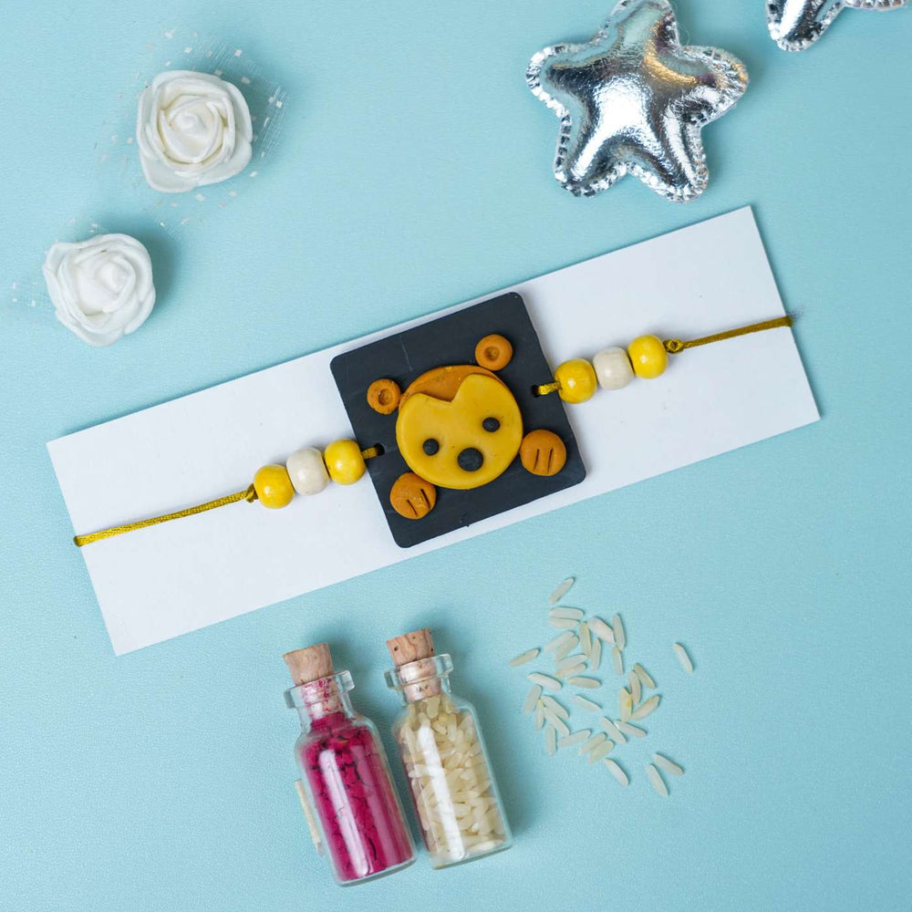 Handmade Miniature Clay Monkey Themed Kids Rakhi With Roli Chawal - Flat Lay with Packaging Card