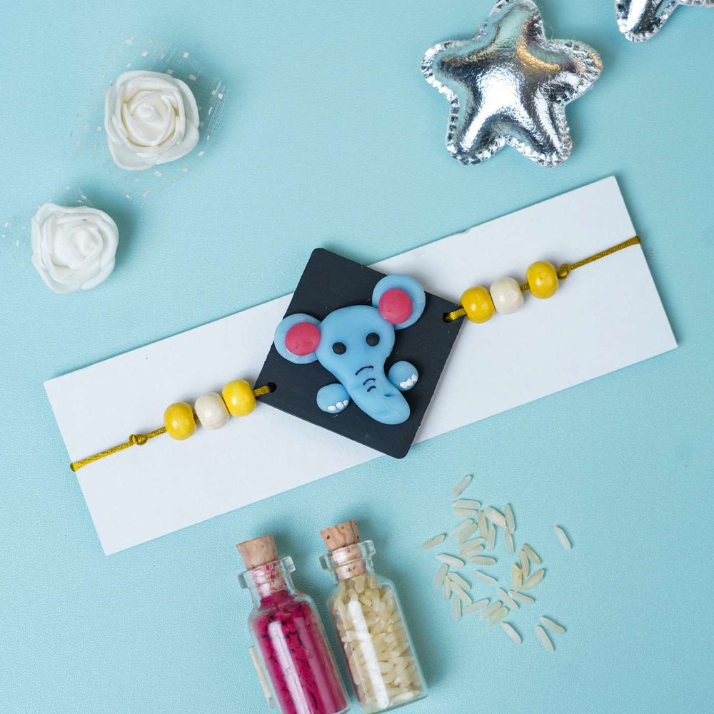 Handmade Miniature Clay Elephant Themed Kids Rakhi With Roli Chawal - Elephant Charm on Display Card