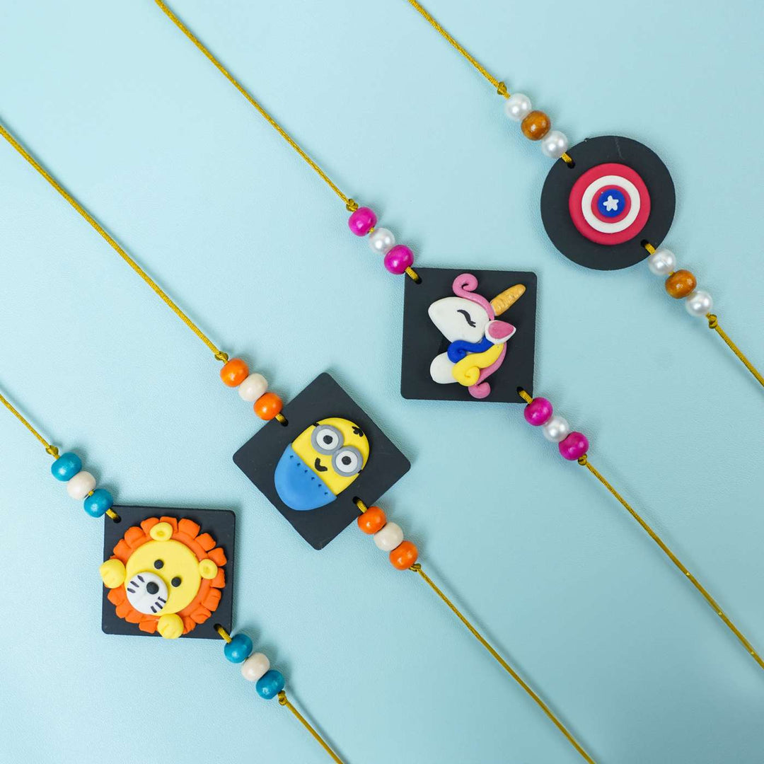 Handmade Miniature Clay Unicorn Kids Rakhi With Roli Chawal - Multiple Character Rakhis Laid Out