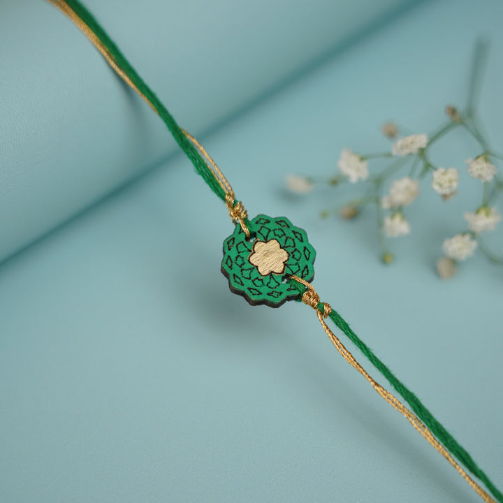 Handmade Green Flower Shape Ghungroo And Shell Wooden Bhaiya Bhabhi Rakhi With Roli Chawal - Single Bracelet Front View