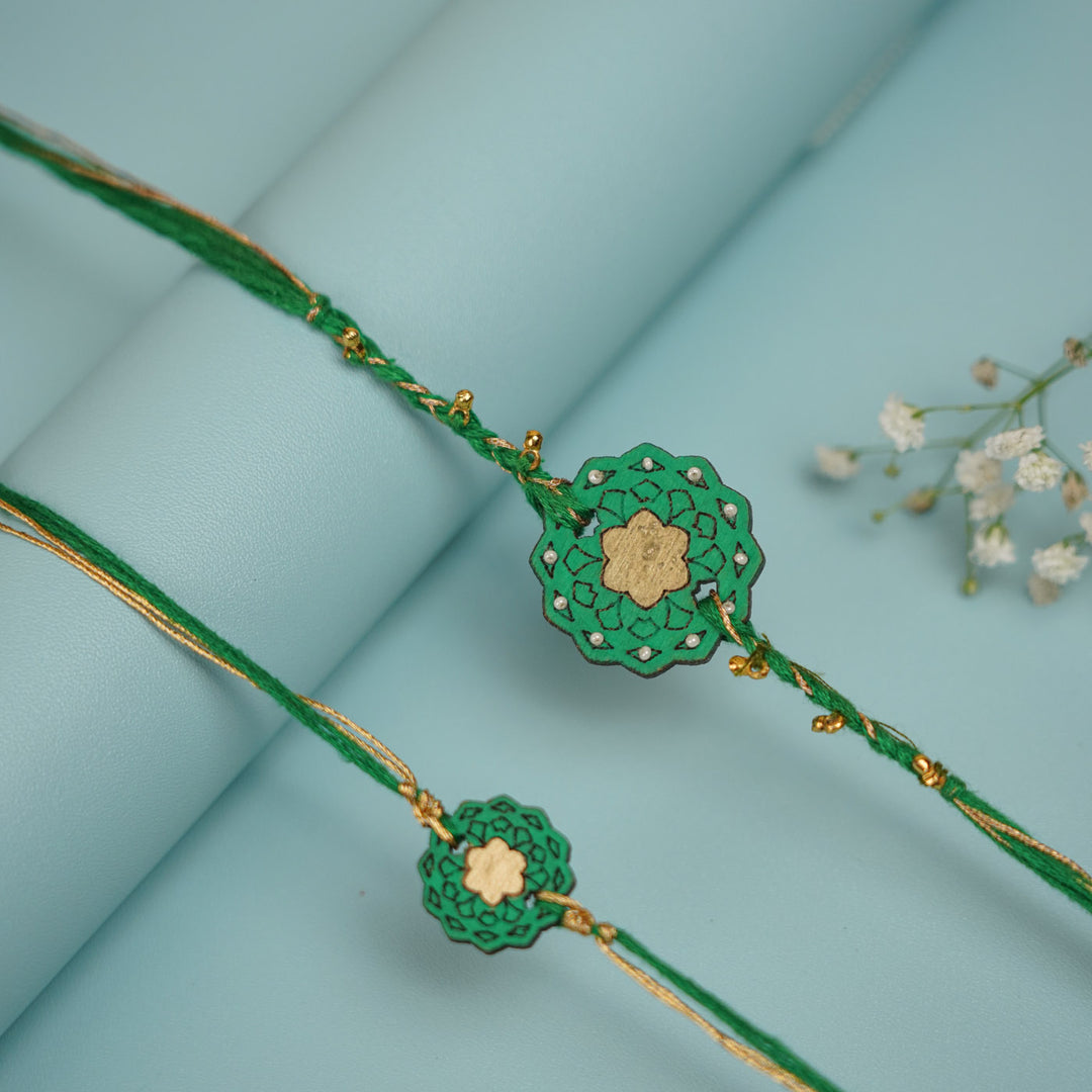Handmade Green Flower Shape Ghungroo And Shell Wooden Bhaiya Bhabhi Rakhi With Roli Chawal - Pair Display Front View