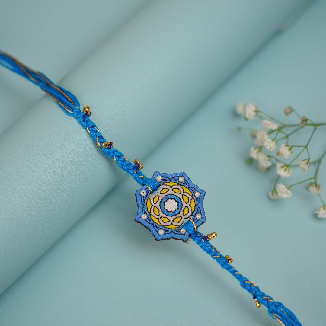 Handmade Blue Jaipuri Ghungroo And Shell Wooden Bhaiya Bhabhi Rakhi With Roli Chawal - Single Bracelet Front View
