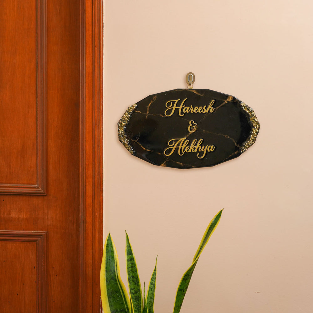 Personalized Oval Black And Gold Resin Name Plate For Couples - Mounted on Wall Showing Placement