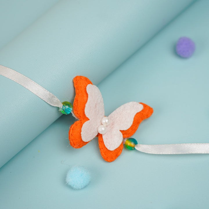Customized Handmade Beaded Butterfly Theme Pom Pom Felt Rakhi With Roli Chawal For Kids - Close-up on Butterfly Detail