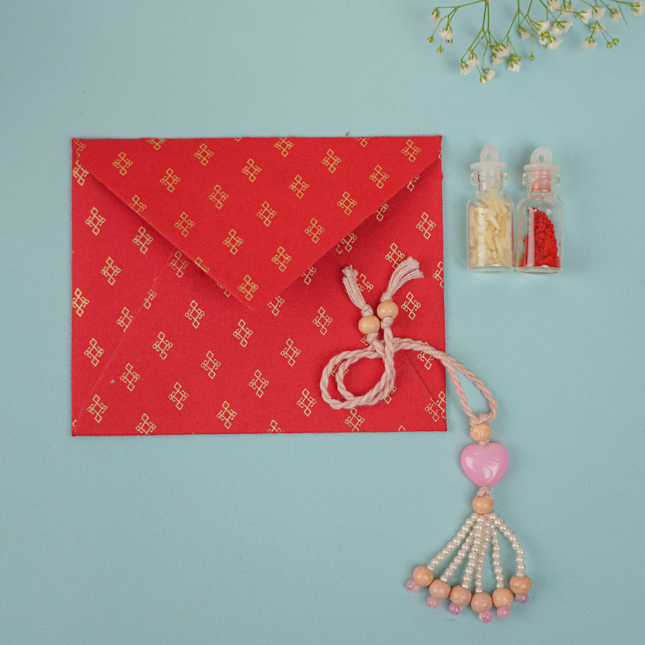 Handmade Beaded Pink Heart Prem Gulika Lumba Rakhi For Bhabhi With Roli Chawal - Displayed with Gift Envelope and Accessories