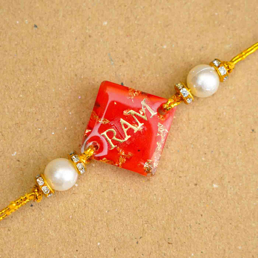 Personalized Handmade Red Resin Rakhi With Roli Chawal - Close-up of Rakhi centerpiece