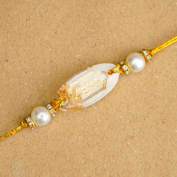 Personalized Handmade White Resin Rakhi With Roli Chawal - Close-up of Oval Design Rakhi