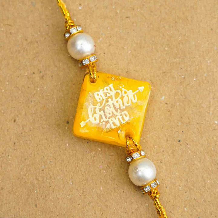 Personalized Handmade Yellow Resin Rakhi With Roli Chawal - Close-up of Bracelet Charm