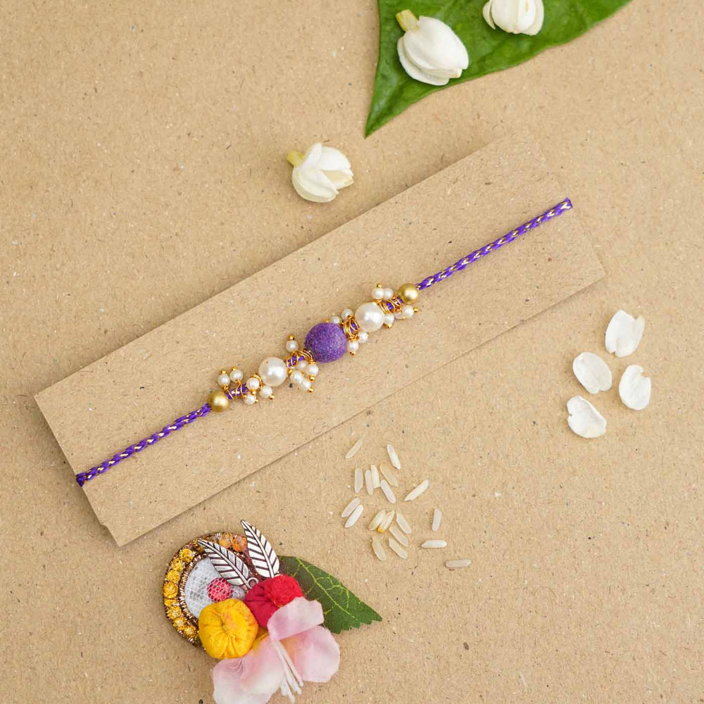 Handmade Beaded Velvet Rakhi With Roli Chawal - Bracelet on kraft paper background