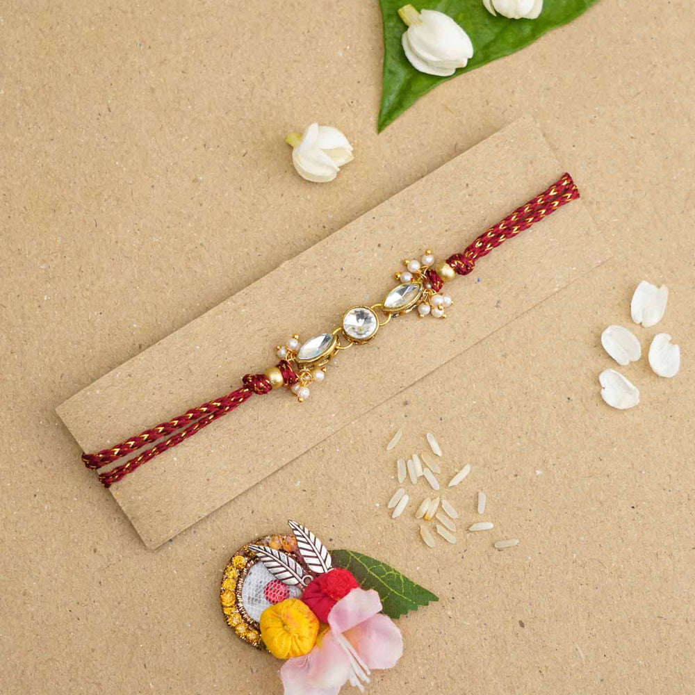 Handmade White Kundan Pearl Rakhi With Roli Chawal - Rakhi on packaging card