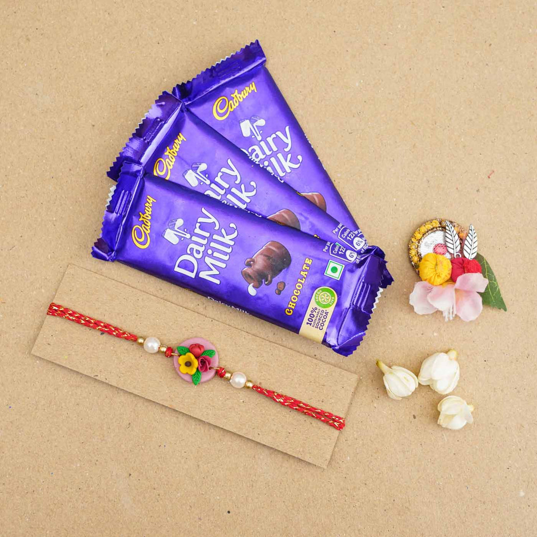 Handmade Miniature Clay Yellow And Red Floral Rakhi With Roli Chawal - Product with chocolate pack
