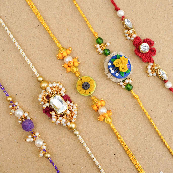 Handmade Kundan Floral Red Rakhi With Roli Chawal - Group display of multiple bracelets