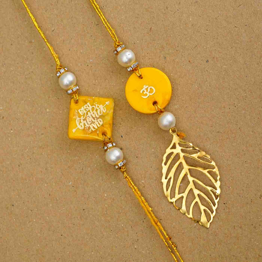 Personalized Handmade Yellow Resin Bhaiya Bhabhi Rakhi With Roli Chawal Set Of 2 - Close-up of two bracelets