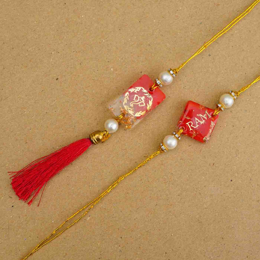 Personalized Handmade Red Resin Bhaiya Bhabhi Rakhi With Roli Chawal Set Of 2 - Close-up of two rakhis