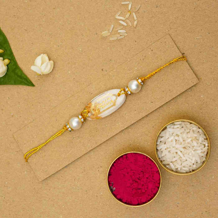 Personalized Handmade White Resin Rakhi With Roli Chawal - Flat Lay with Rice and Kumkum (6)