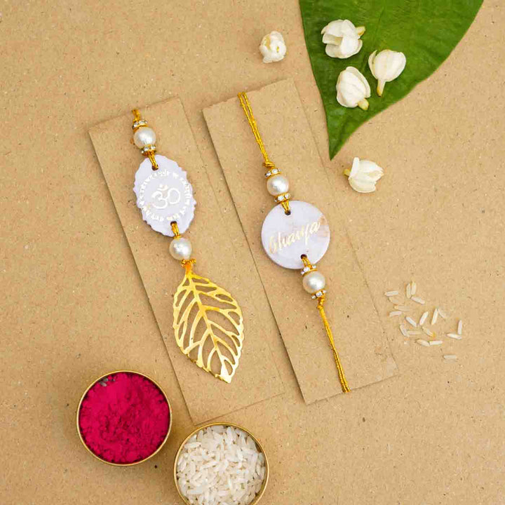Personalized Handmade Lavendar Resin Bhaiya Bhabhi Rakhi With Roli Chawal Set Of 2 - Front View with Decorative Items