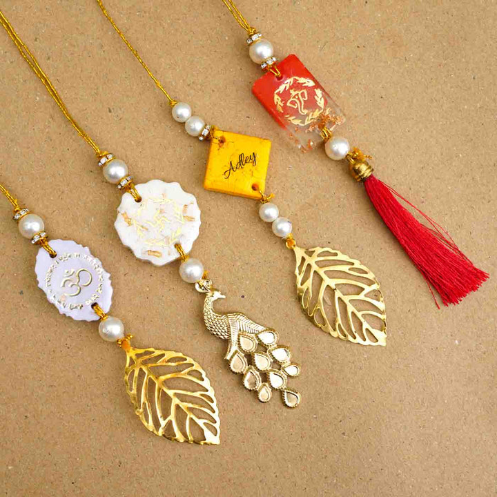 Personalized Handmade Red Resin Lumba Rakhi For Bhabhi With Roli Chawal - Multiple Rakhi Threads Laid Out