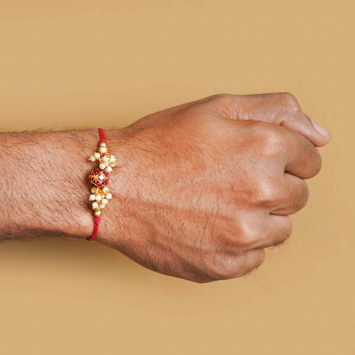 Handmade Red Meena Bead Pearl Rakhi With Roli Chawal - Rakhi worn on wrist