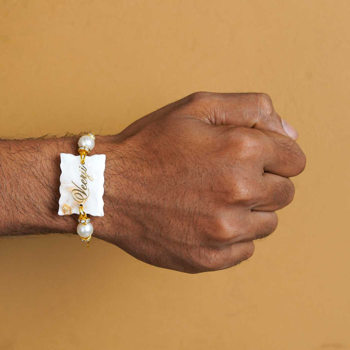 Personalized Handmade White Resin Rakhi With Roli Chawal - Worn on Wrist Display