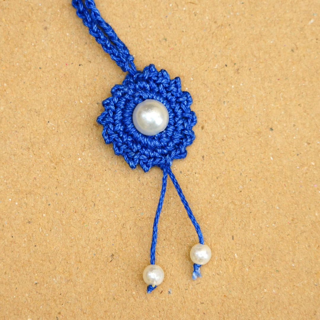 Handmade Crochet Round Pearl Cotton Lumba Rakhi For Bhabhi With Roli Chawal - Close-up of bracelet end detail
