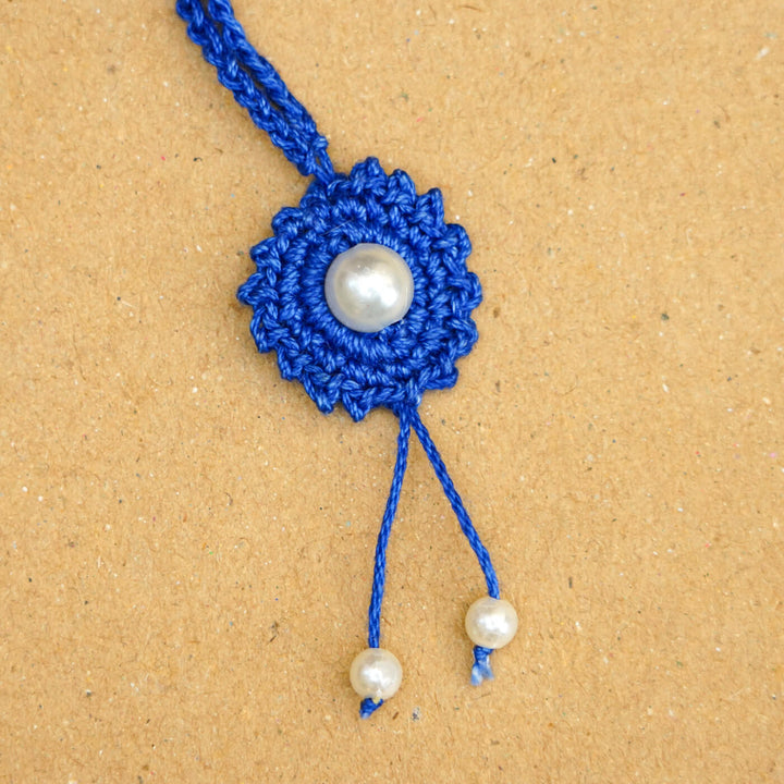 Handmade Crochet Round Pearl Cotton Lumba Rakhi For Bhabhi With Roli Chawal - Close-up of bracelet end detail