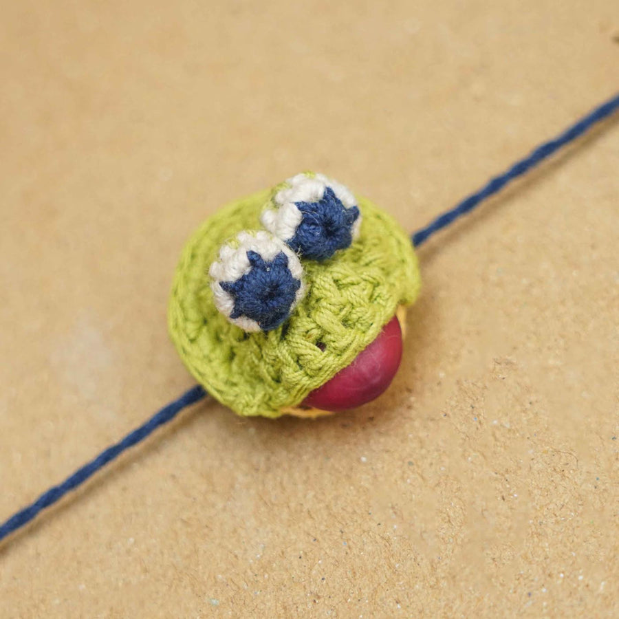Eco Friendly Handmade Plantable Frog Theme Kids Rakhi With Roli Chawal - Close-up of Crochet Charm