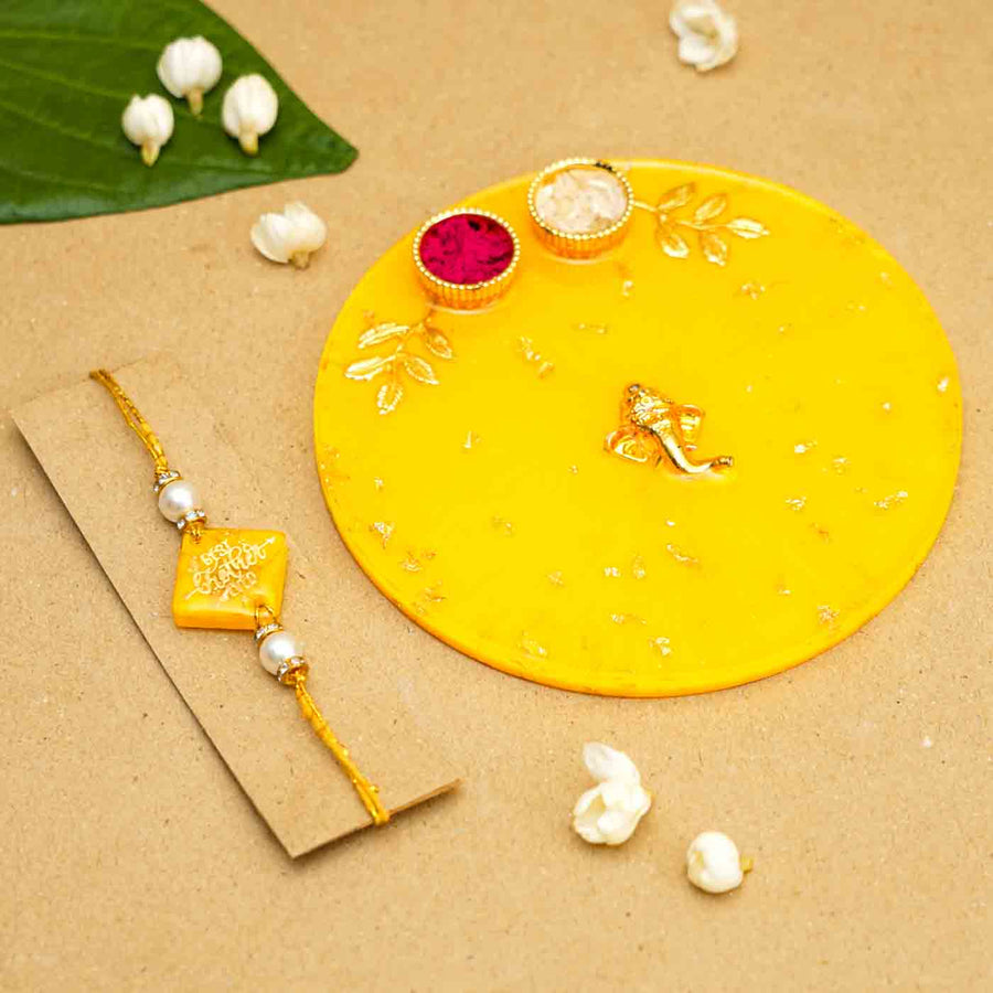 Personalized Handmade Yello Resin Rakhi Thali With Roli Chawal For Brother Set Of 2 - Rakhi and plate styled display