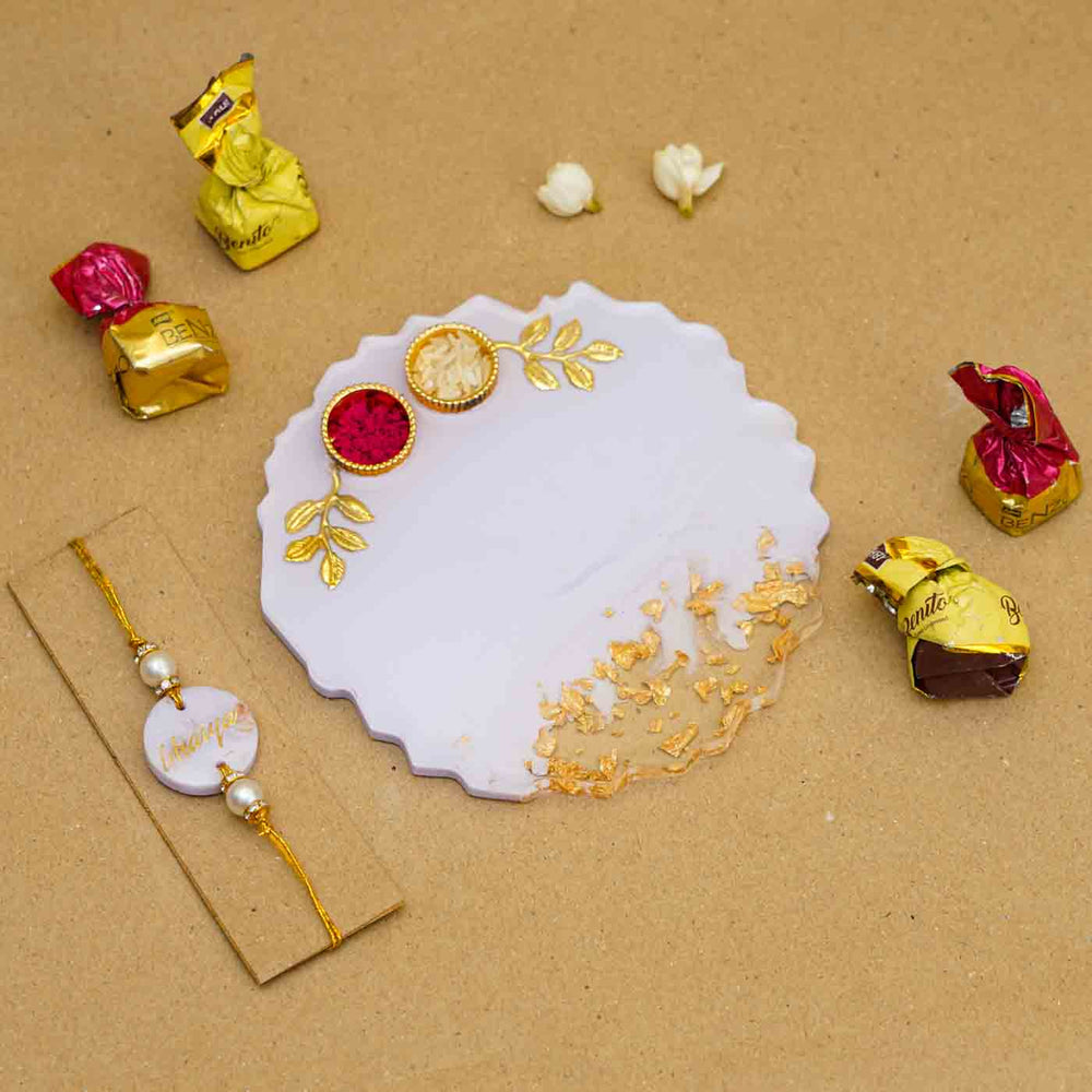 Personalized Handmade Lavendar Resin Rakhi Thali With Roli Chawal For Brother Set Of 2 - Flat Lay with Rakhi, Plate, Chocolates