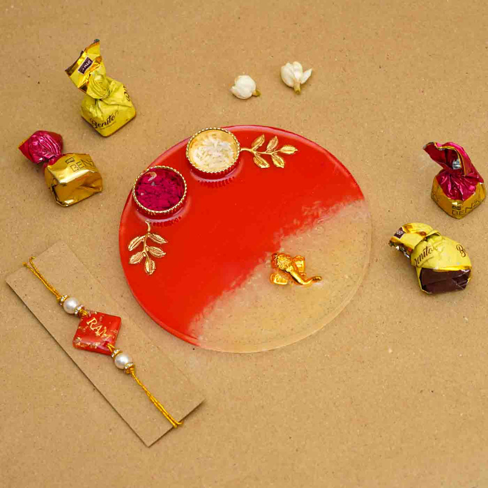 Personalized Handmade Red Resin Rakhi Thali With Roli Chawal For Brother Set Of 2 - Flat Lay with Rakhi, Plate, Chocolates
