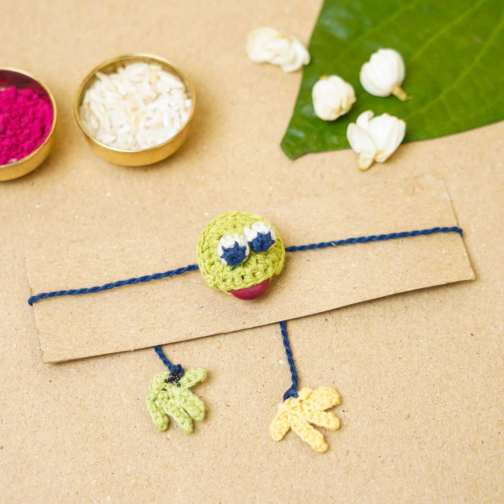 Eco Friendly Handmade Plantable Frog Theme Kids Rakhi With Roli Chawal - Flat Lay with Card and Decorations