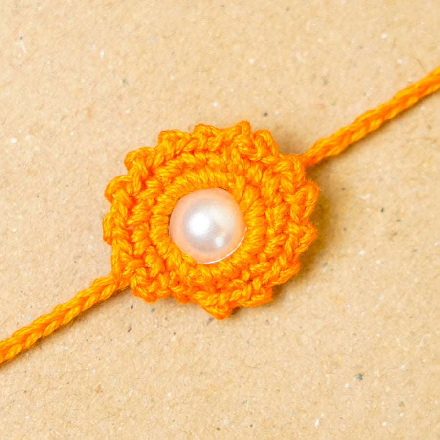 Handmade Crochet Round Pearl Cotton Rakhi With Roli Chawal - Close-up of yellow centerpiece