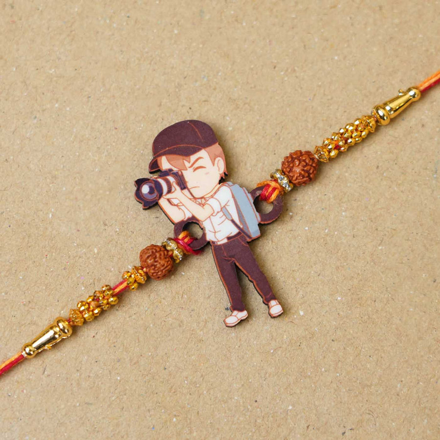 Handmade Printed Photographer Bhai Wooden Rudraksha Rakhi With Roli Chawal - Close-up of charm detail