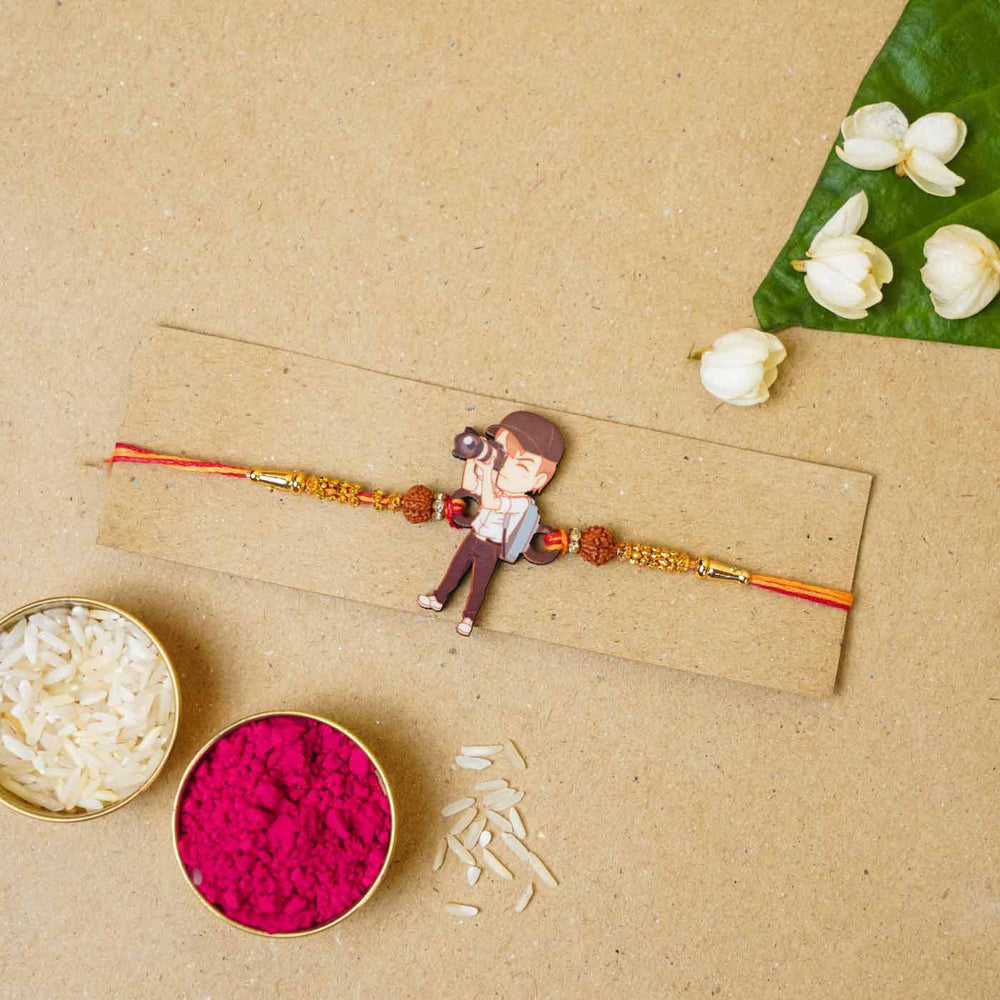 Handmade Printed Photographer Bhai Wooden Rudraksha Rakhi With Roli Chawal - Packaged with decorative elements