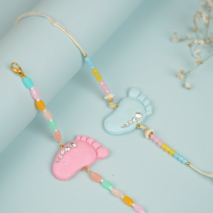 Handmade Blue And Pink Baby Feet Clay Bhaiya Bhabhi Rakhi With Roli Chawal Set Of 2 - Side View Showing Detail