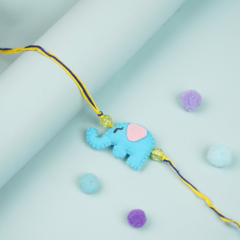 Handmade Elephant Theme Felt Kids Rakhi - Flat Lay with Rolled Background