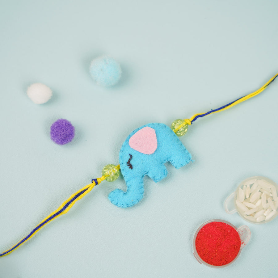 Handmade Elephant Theme Felt Kids Rakhi - Flat Lay with Decorative Elements