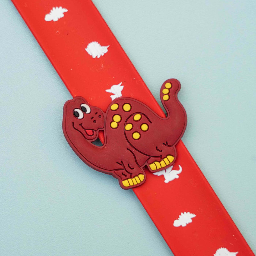 Handmade Dino Slap Band Kids Rakhi With Roli Chawal - Close-up of Dinosaur Clip