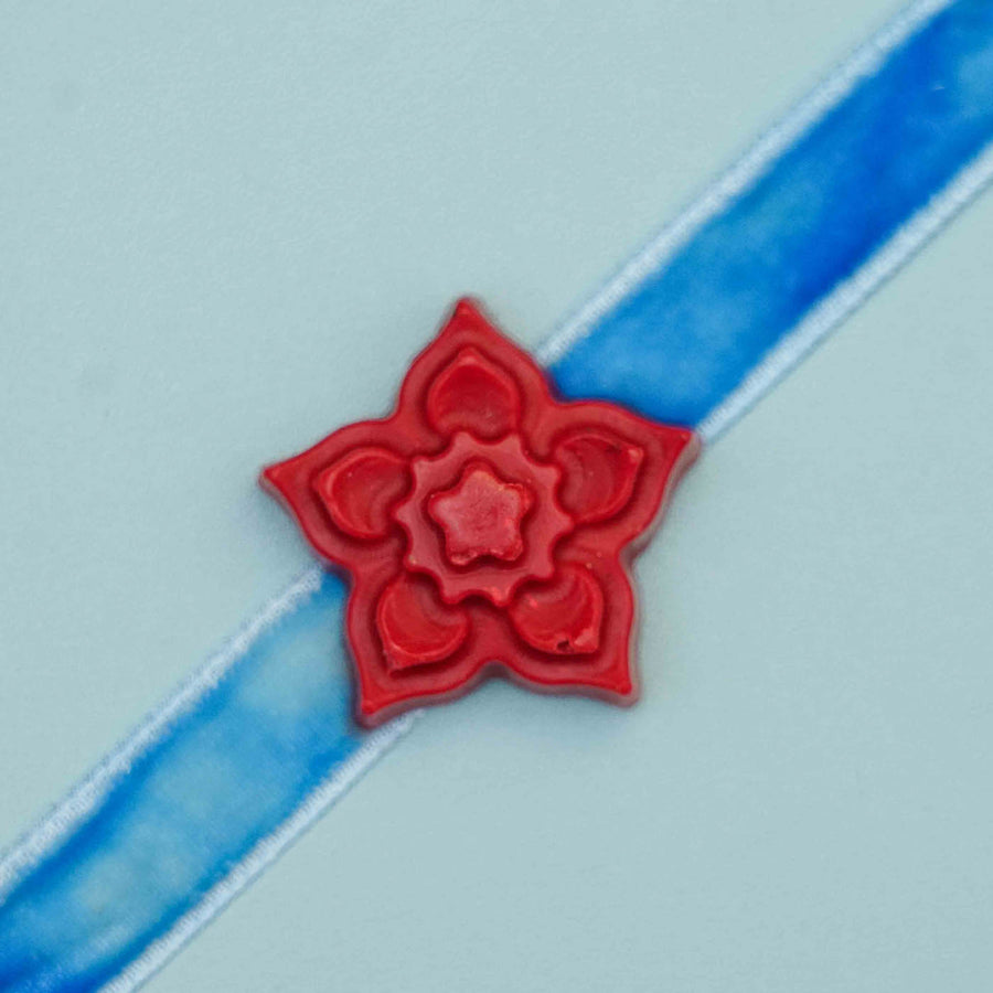 Handmade Flower Crayon Kids Rakhi With Roli Chawal - Close-up of red flower decoration