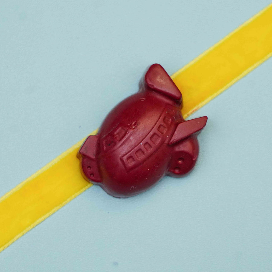 Handmade Airplane Crayon Kids Rakhi With Roli Chawal - Close-up of Airplane Charm