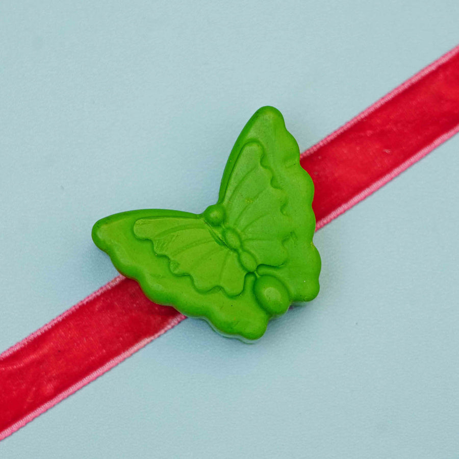 Handmade Butterfly Crayon Kids Rakhi With Roli Chawal - Close-up of butterfly clip