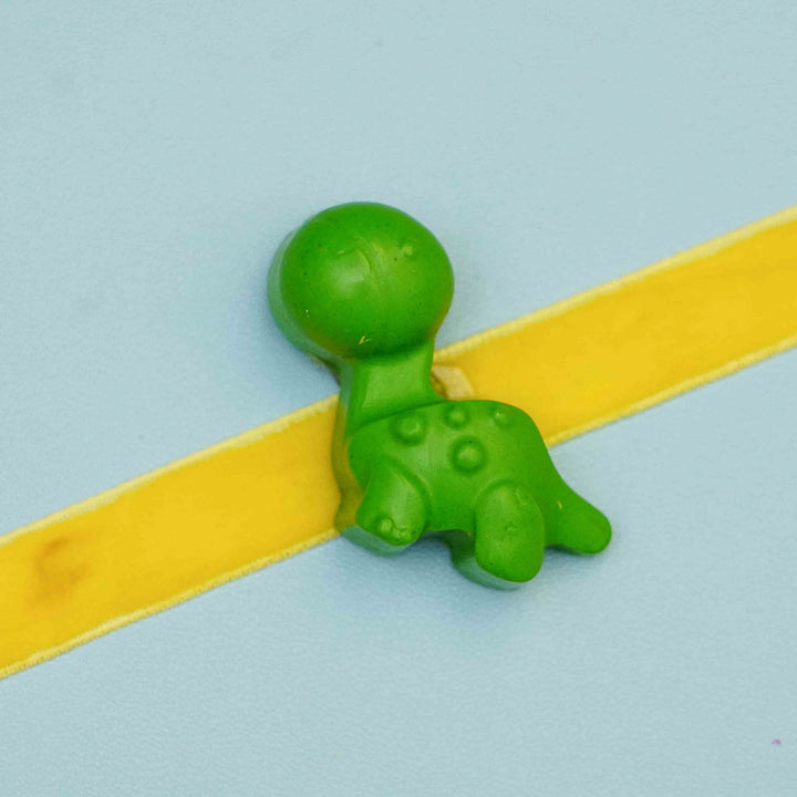 Handmade Dino Crayon Kids Rakhi With Roli Chawal - Close-up of green dinosaur charm variant