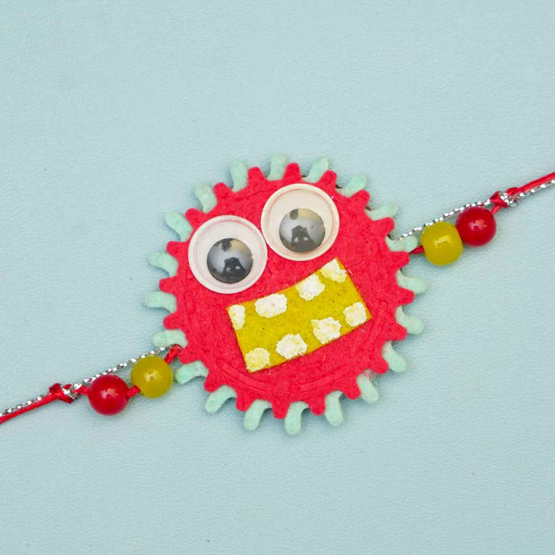 Handmade Monster Theme Felt Kids Rakhi With Roli Chawal - Close-up of Red Monster Rakhi