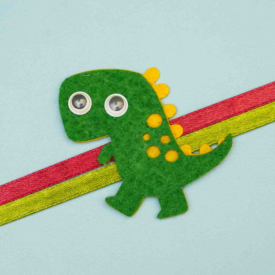 Handmade Dinasour Theme Felt Kids Rakhi With Roli Chawal For Brother - Close-up of Dino Rakhi