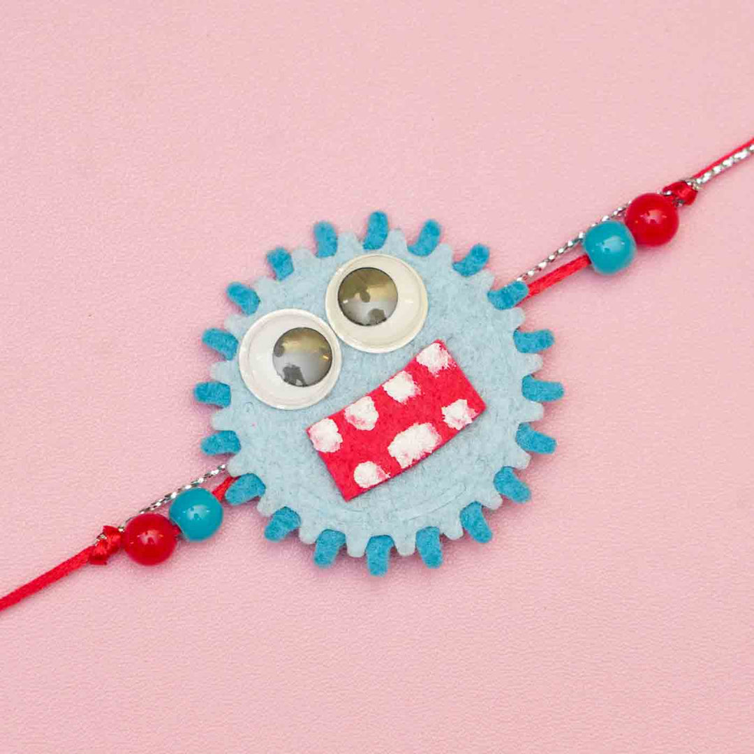 Handmade Monster Theme Felt Kids Rakhi With Roli Chawal - Close-up of Blue Monster Rakhi