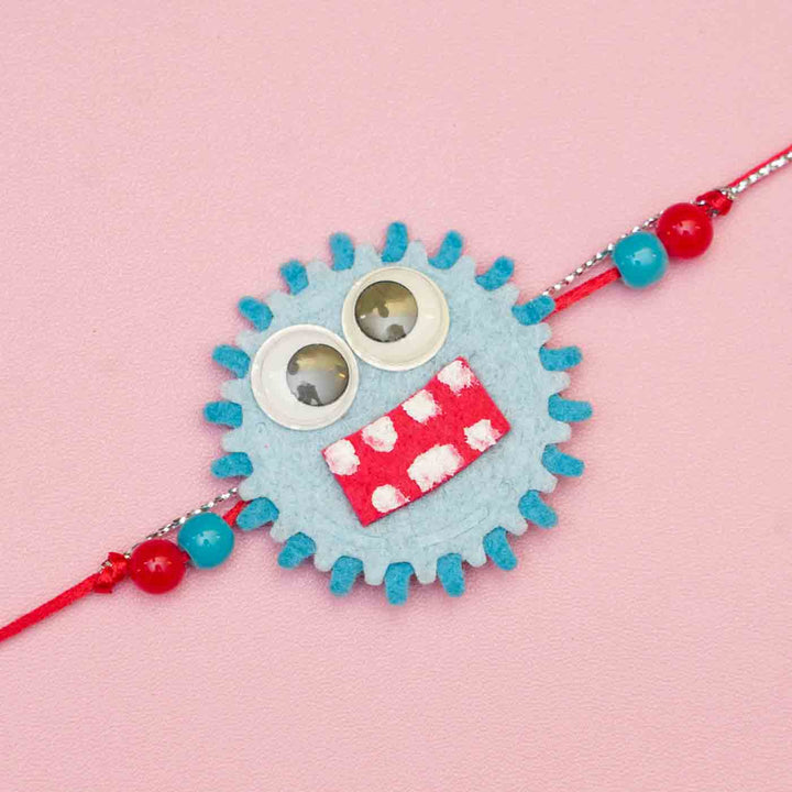 Handmade Monster Theme Felt Kids Rakhi With Roli Chawal - Close-up of Blue Monster Rakhi