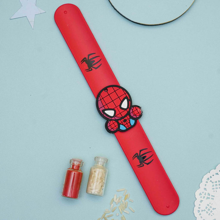 Handmade Spiderman Slap Band Kids Rakhi With Roli Chawal - Flat Lay with Decorative Items