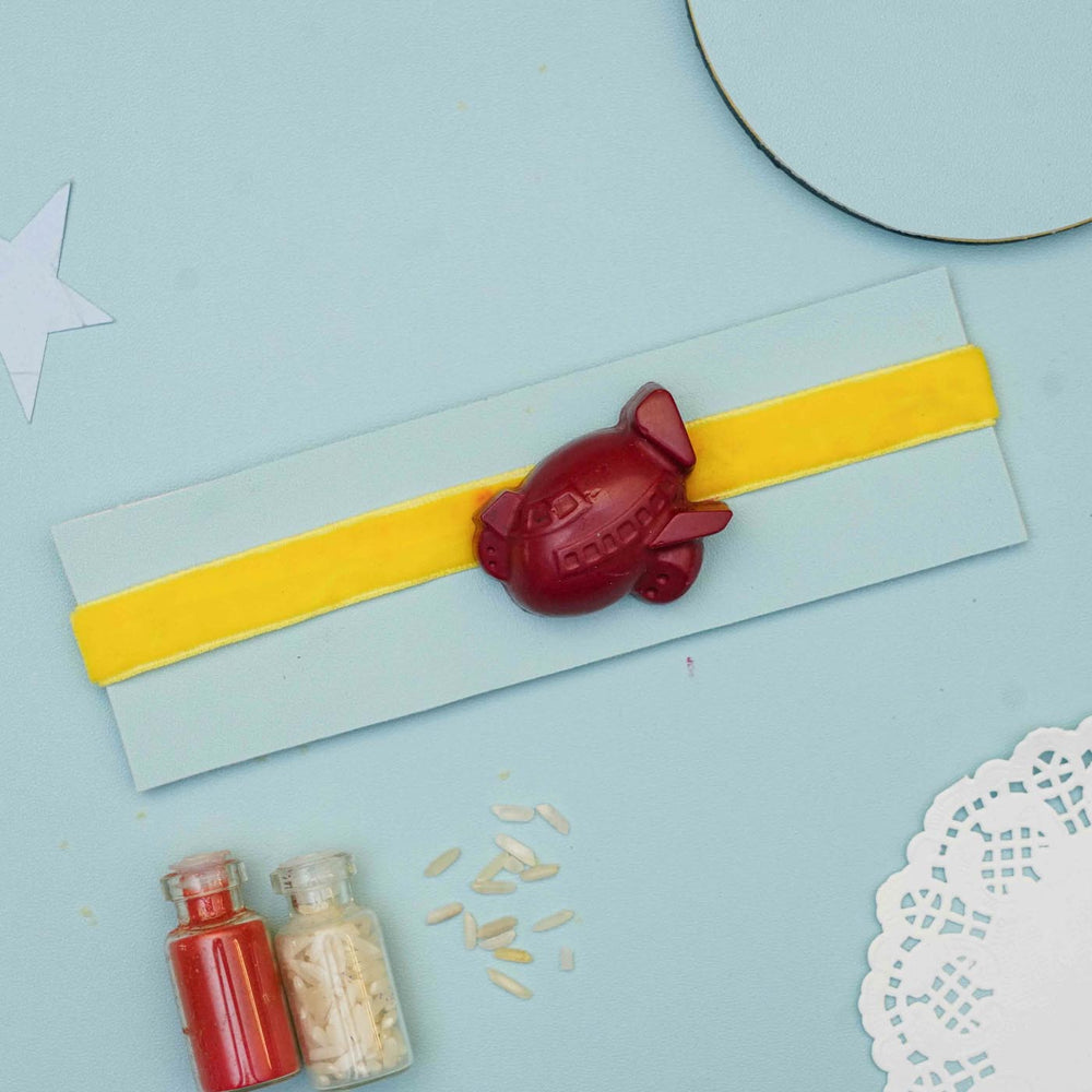 Handmade Airplane Crayon Kids Rakhi With Roli Chawal - Wide View with Packaging and Accessories