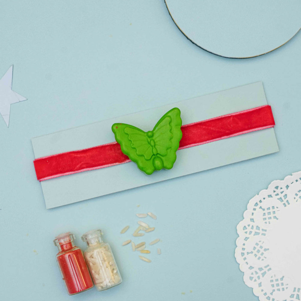 Handmade Butterfly Crayon Kids Rakhi With Roli Chawal - Full product display with background props