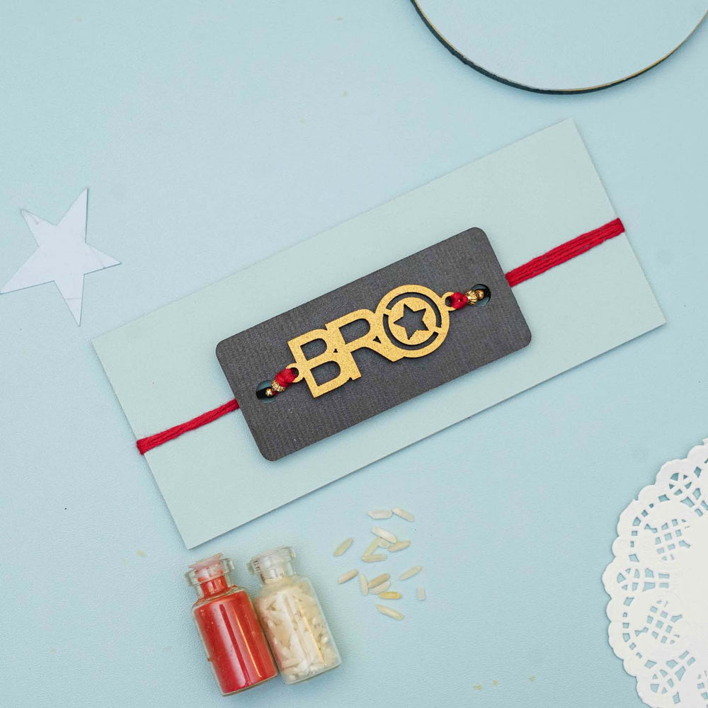 Handmade Bro Mdf Rakhi With Roli Chawal - Styled Flat Lay with Accessories